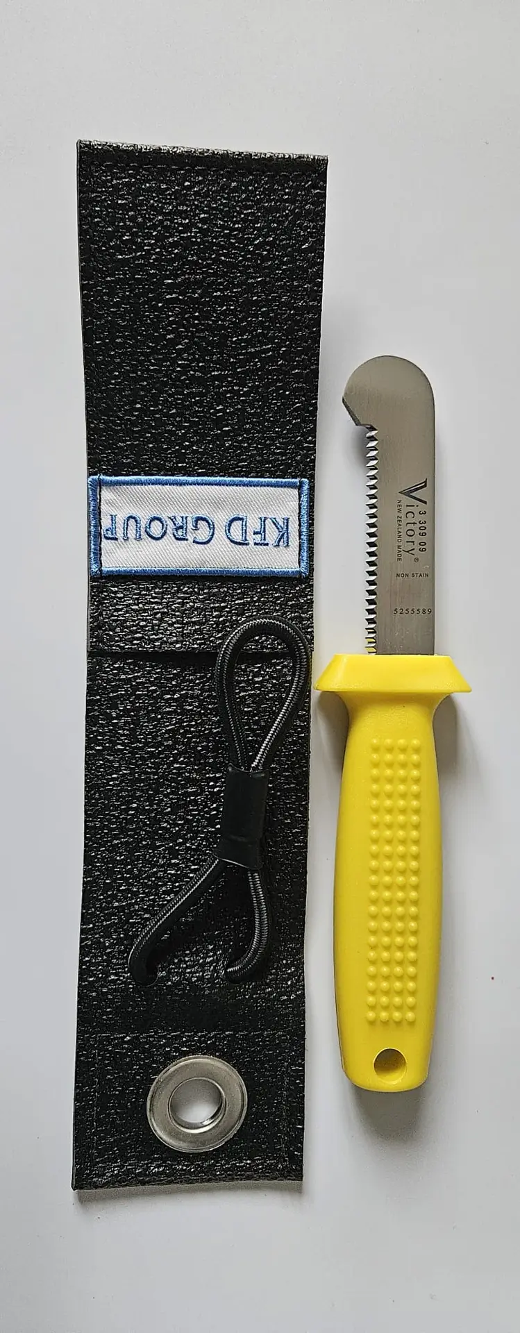 KFD Group's Safety Knife with Flex Sheath 9cm. Designed for tough offshore work, this knife offers durability and a secure grip. Trusted for 70 years.